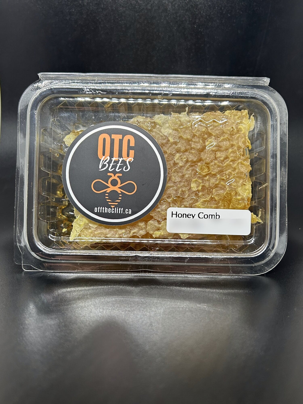 OTC BEES comb honey in a clear container
